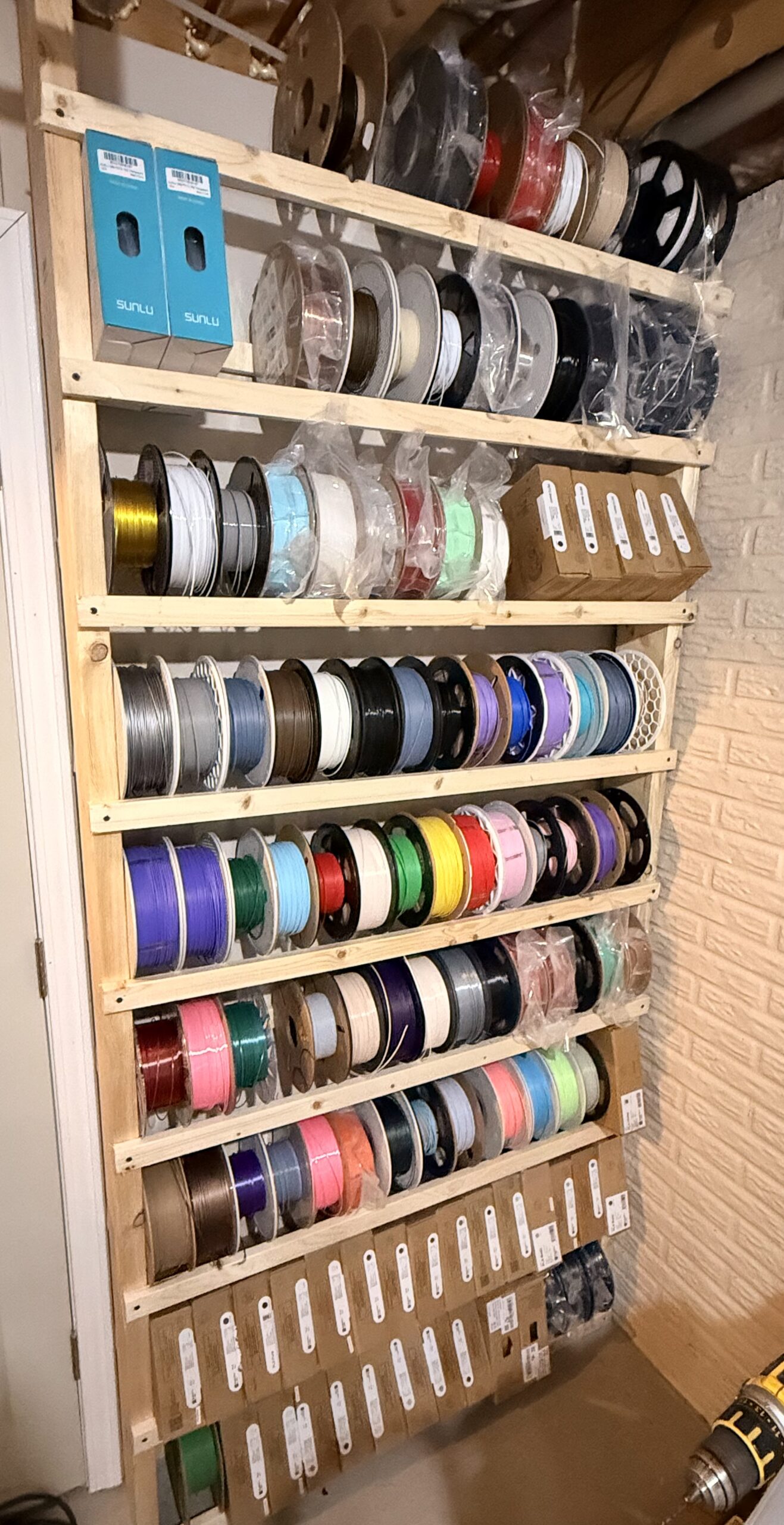 DIY wood filament rack holding 126 spools of 3D printer filament