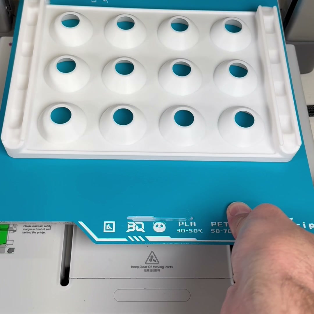 White PLA pill organizer tray on the BIQU CryoGrip Pro plate inside the printer
